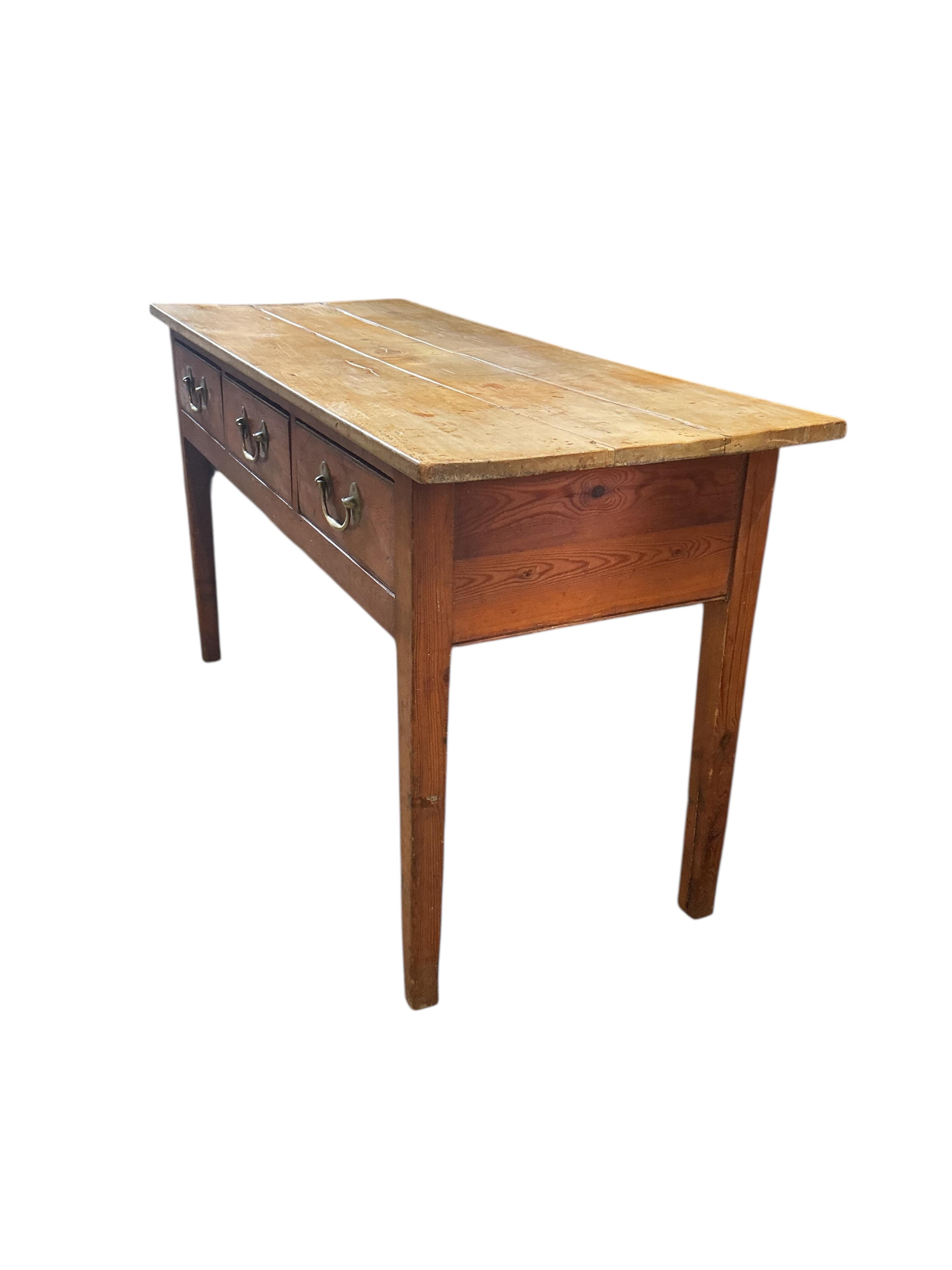 An early 19th century pine and fruitwood three drawer serving table, width 137cm, depth 54cm, height 75cm